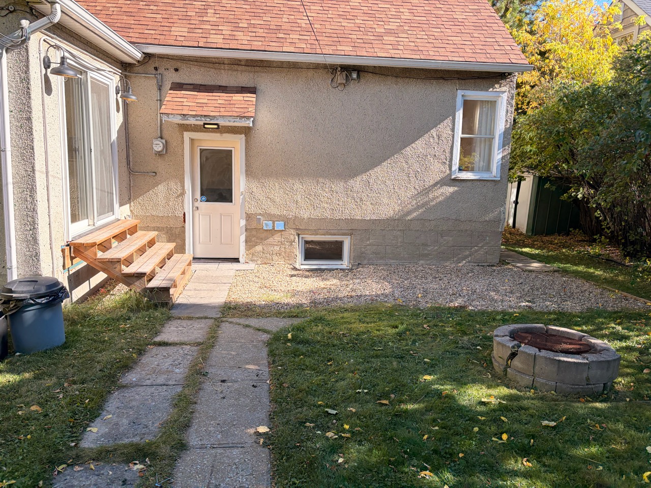 After junk removal: the same backyard with the pile removed and the walkway and gravel area clear