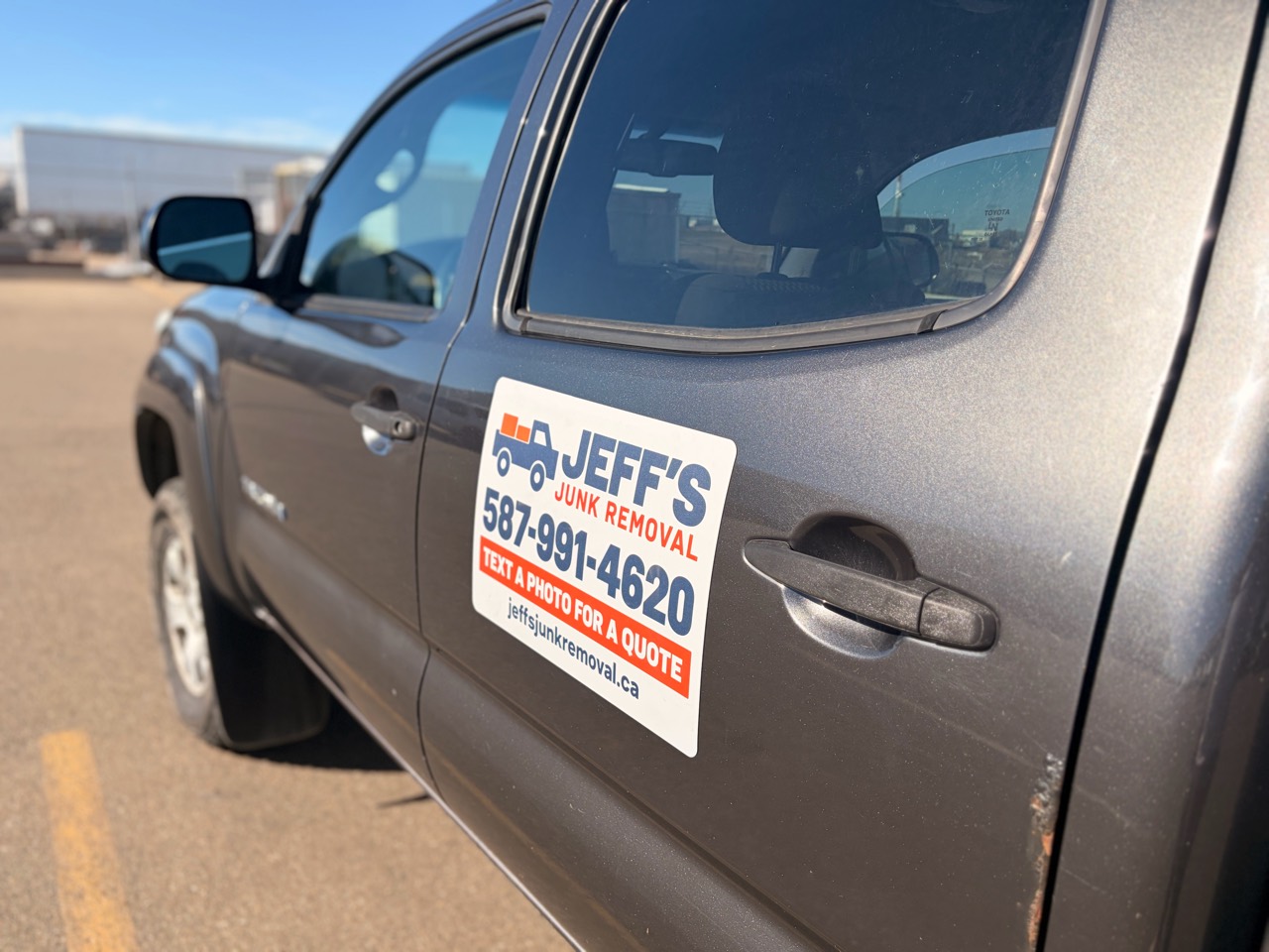 Jeff’s truck magnet showing 587-991-4620 and Text a photo for a quote